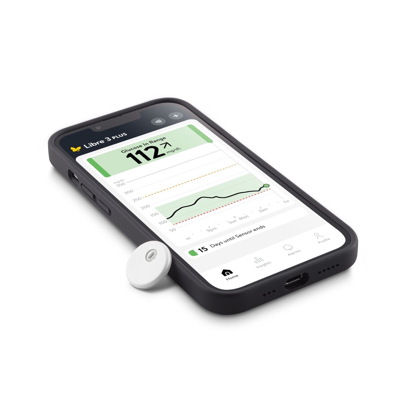 A FreeStyle Libre Sensor next to a smartphone with a Libre sensor app displaying a glucose reading and graph.