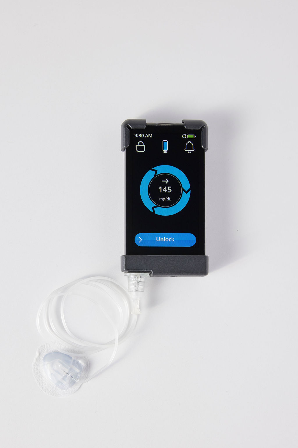 Diabetes device with screen showing glucose 148, connected to white infusion set.
