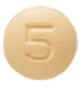 Photograph of a round, light orange pill with the number 5 embossed.