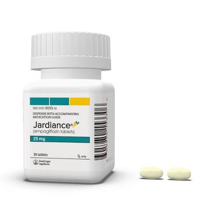 Jardiance 25 mg medication bottle with two light yellow oval pills next to it.