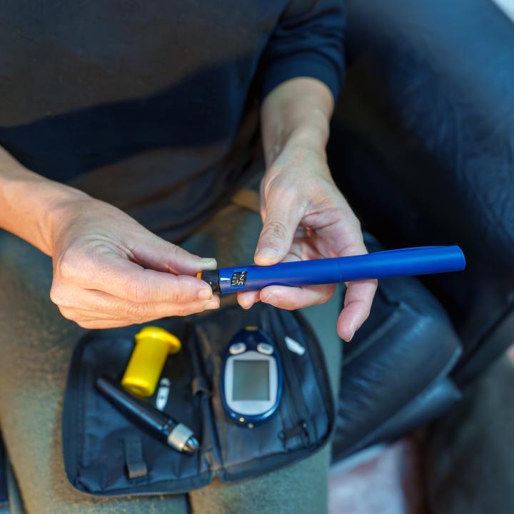 Woman preparing an insulin pen for injection