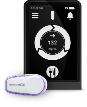 Dexcom G6 and receiver screen displaying glucose level.