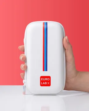 Hand holds a white portable medical case with a vertical red and blue stripe.