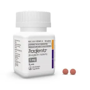 Tradjenta 5mg (linagliptin tablets) medicine bottle with two reddish-brown pills.