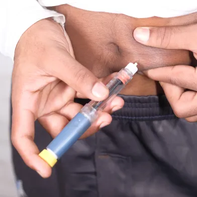young man hand using insulin pen close up