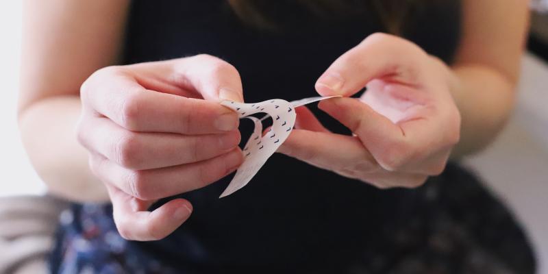 Woman applying adhesive patch for a diabetes product