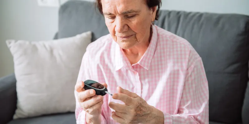 Senior woman testing her blood glucose