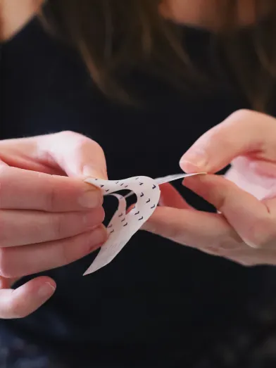 Woman applying adhesive patch for a diabetes product