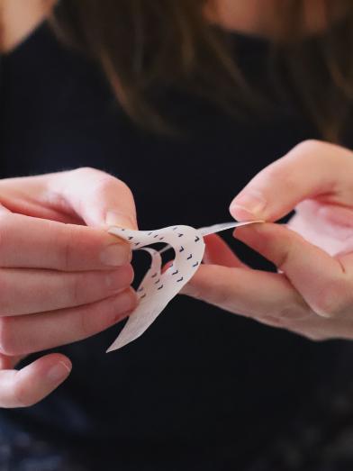 Woman applying adhesive patch for a diabetes product