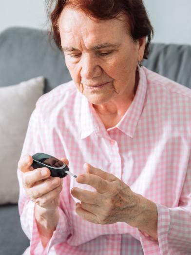 Senior woman testing her blood glucose